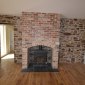 Salvaged red brick wall and fireplace in the living room living room new builds cork