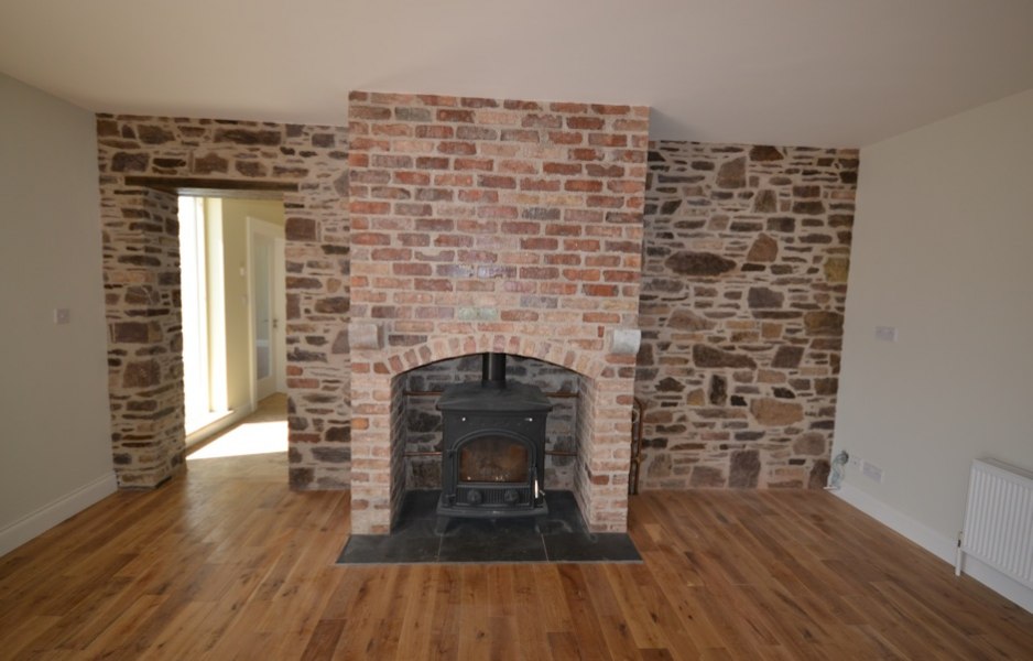 Salvaged red brick wall and fireplace in the living room living room new builds cork